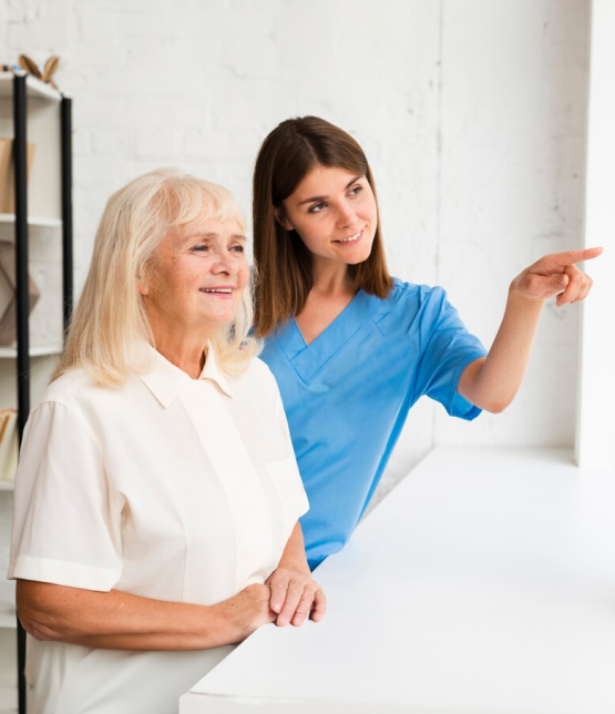 Female care worker guides smiling elderly woman at home, exemplifying attentive domiciliary care services